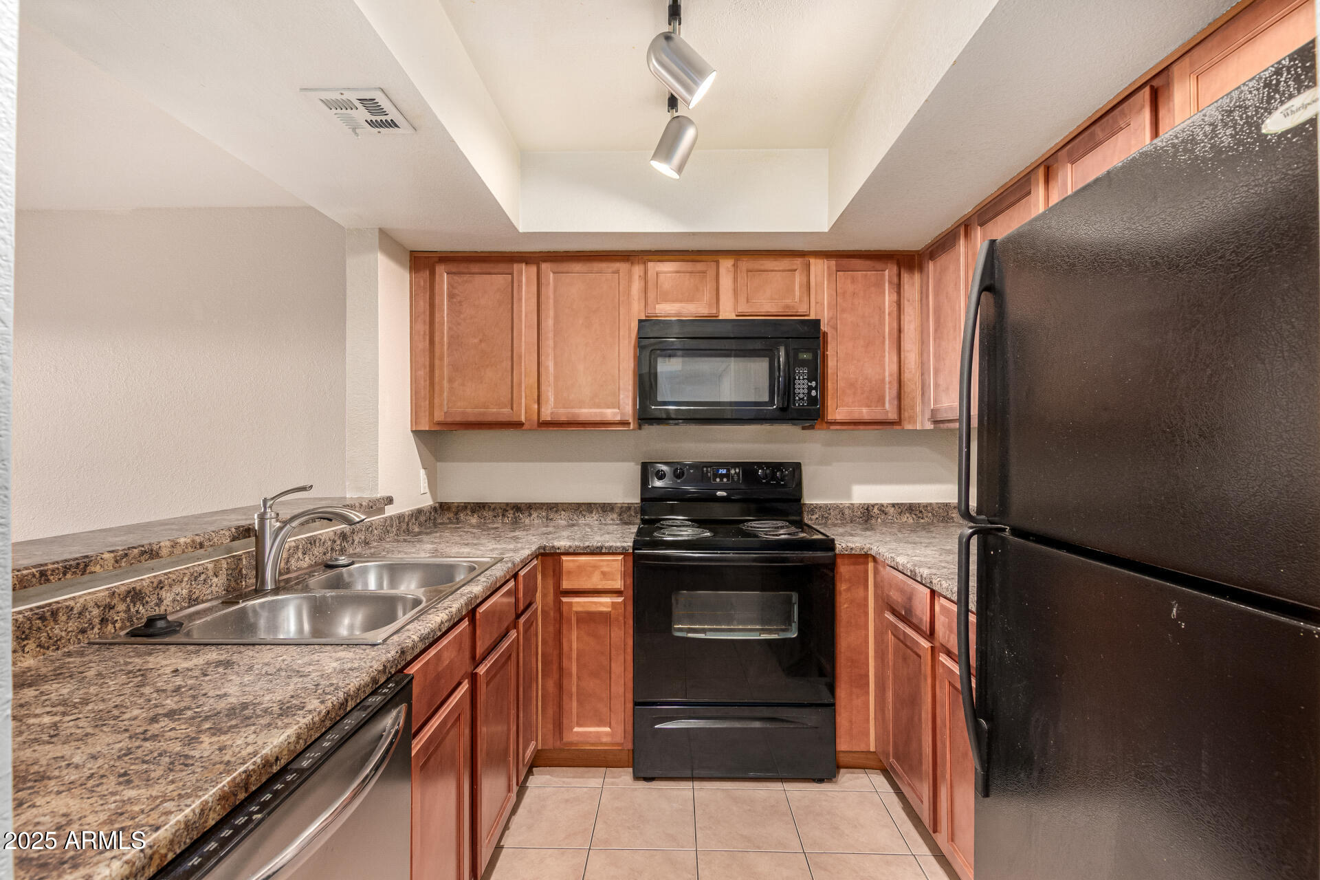 1331 West Baseline Road, Unit 167 Mesa, AZ 85202 - Photo 11 of 42 a kitchen with stainless steel appliances granite countertop a sink stove microwave and refrigerator