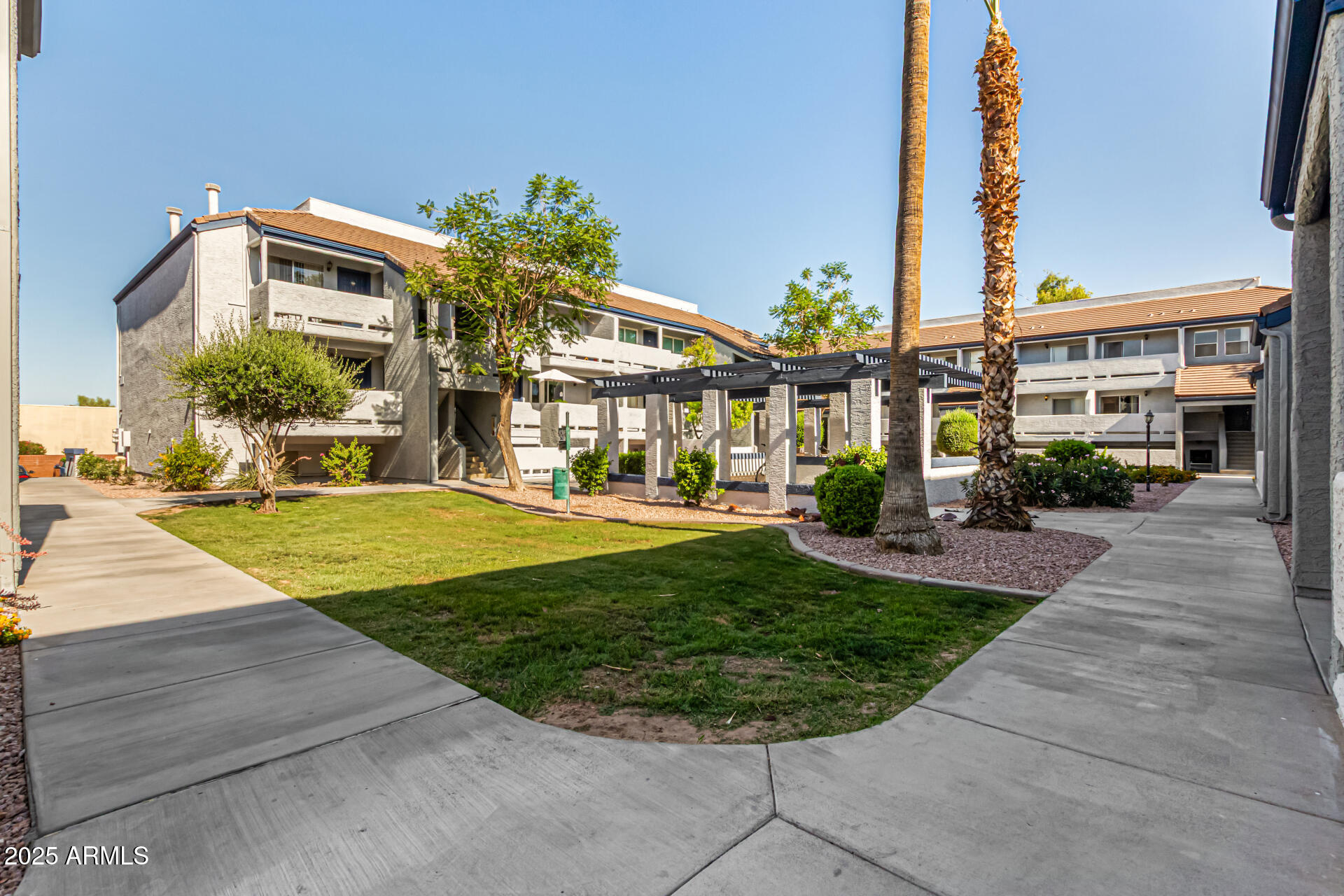 1331 West Baseline Road, Unit 167 Mesa, AZ 85202 - Photo 2 of 42 a front view of a building with garden