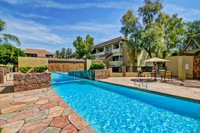 a view of a house with swimming pool and sitting area