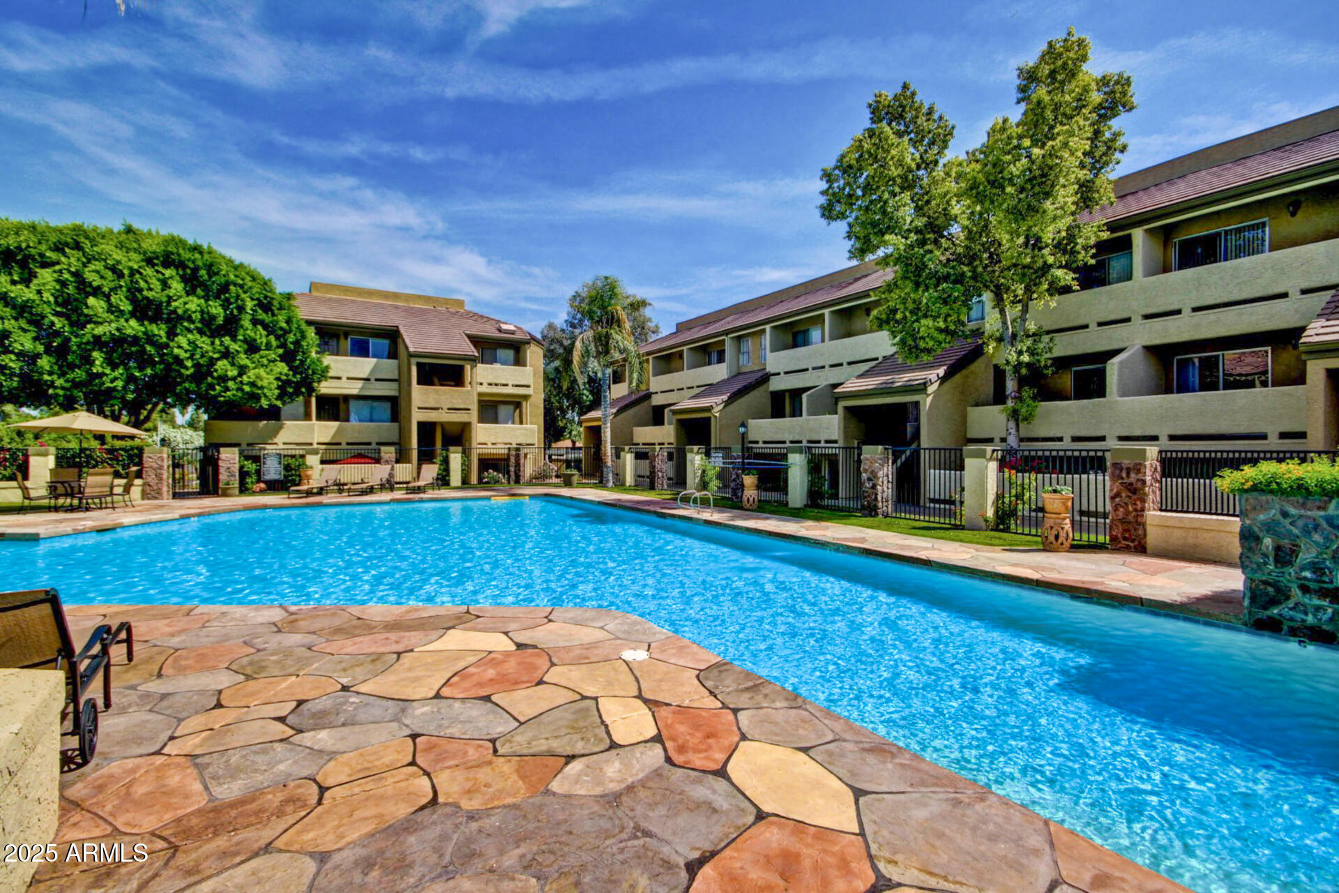 1331 West Baseline Road, Unit 167 Mesa, AZ 85202 - Photo 34 of 42 a swimming pool with outdoor seating