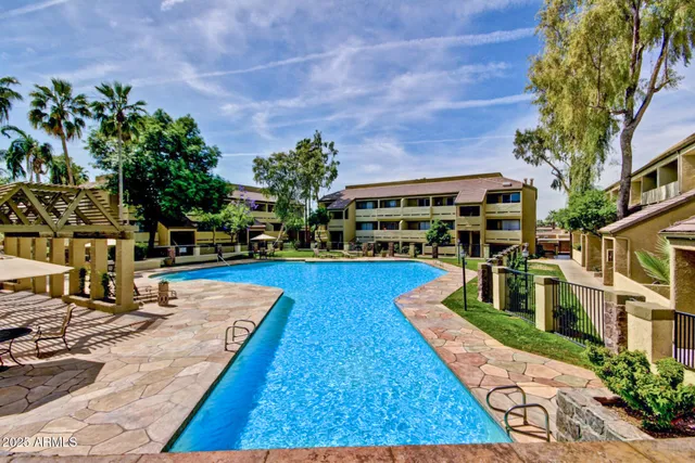 a swimming pool with outdoor seating yard and barbeque oven