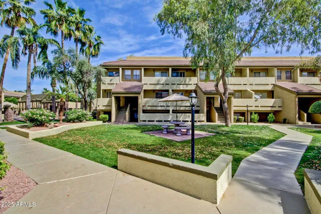 a front view of a building with a garden
