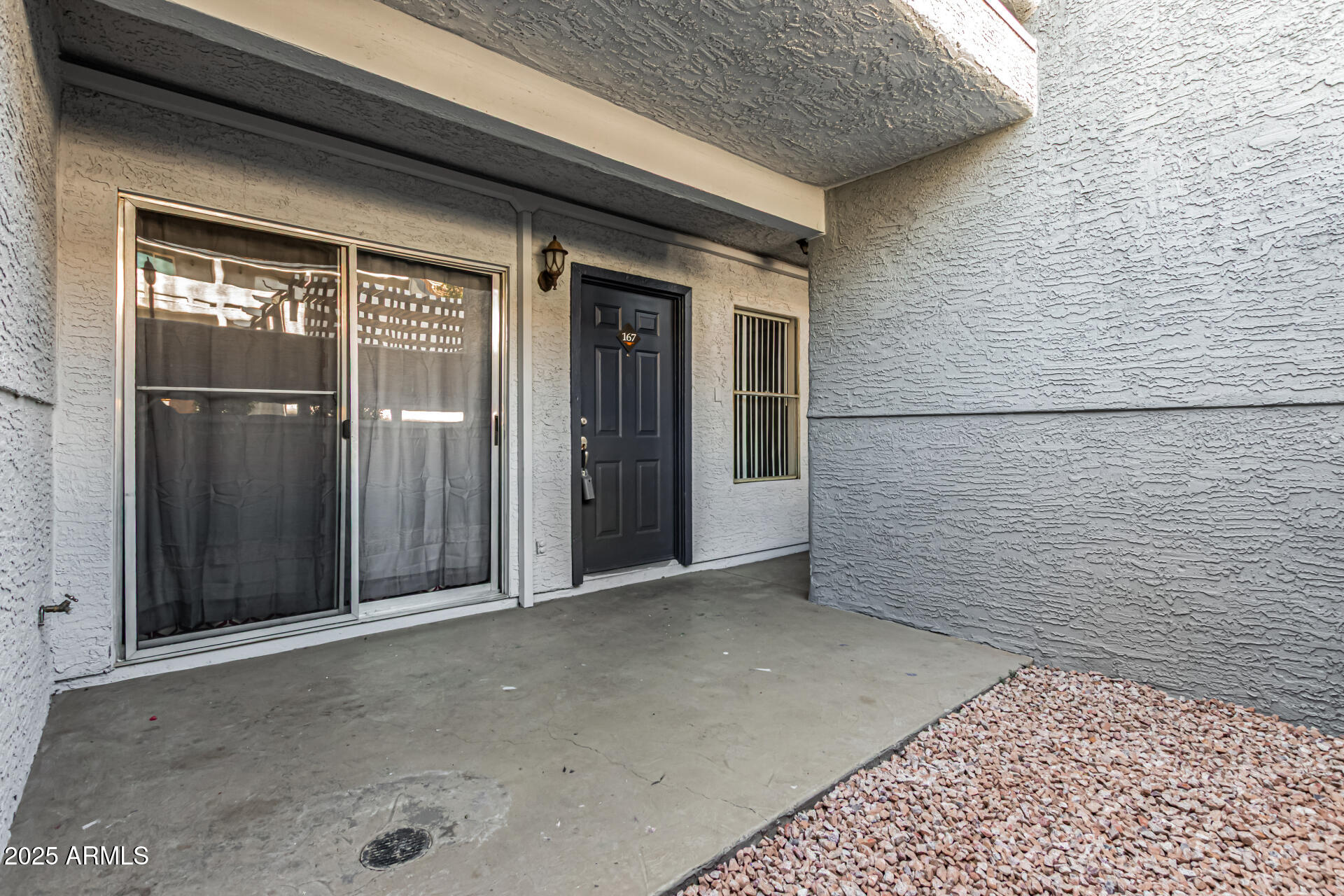 1331 West Baseline Road, Unit 167 Mesa, AZ 85202 - Photo 5 of 42 a view of a brick house with a wooden fence
