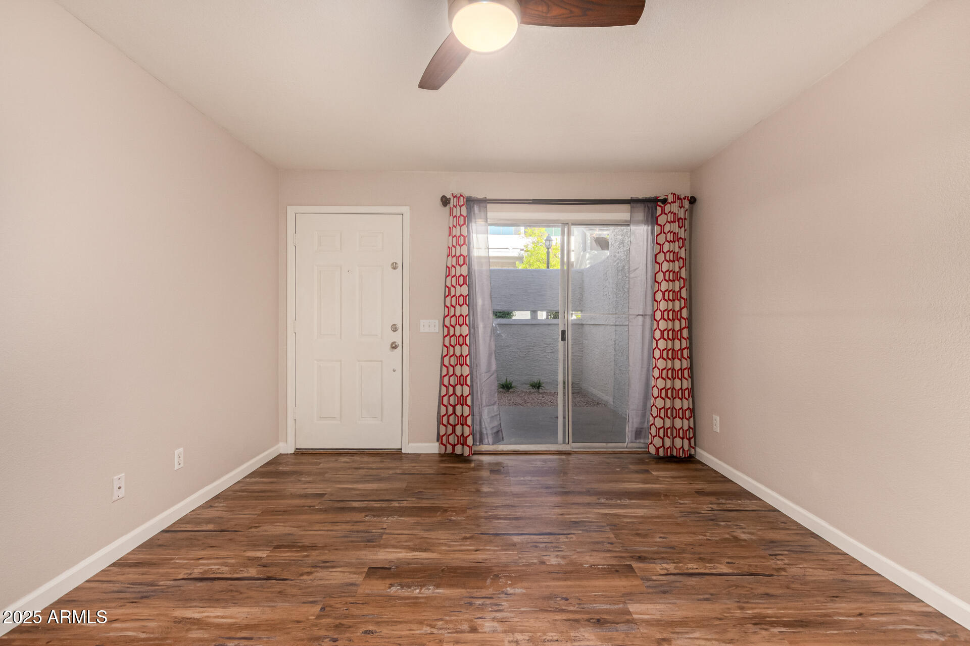 1331 West Baseline Road, Unit 167 Mesa, AZ 85202 - Photo 6 of 42 wooden floor in an empty room with a window