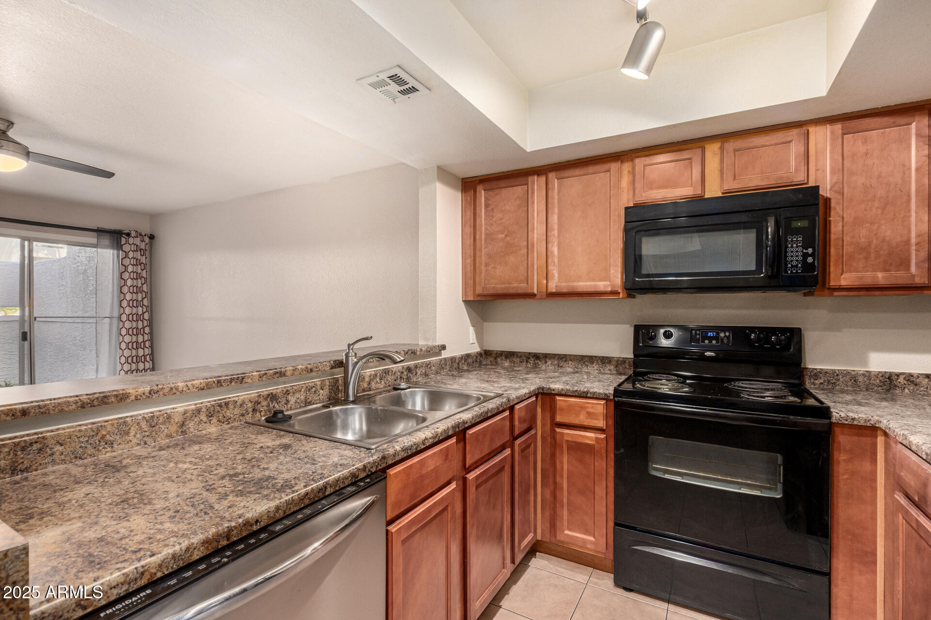 1331 West Baseline Road, Unit 167 Mesa, AZ 85202 - Photo 10 of 42 a kitchen with granite countertop a sink and steel appliances