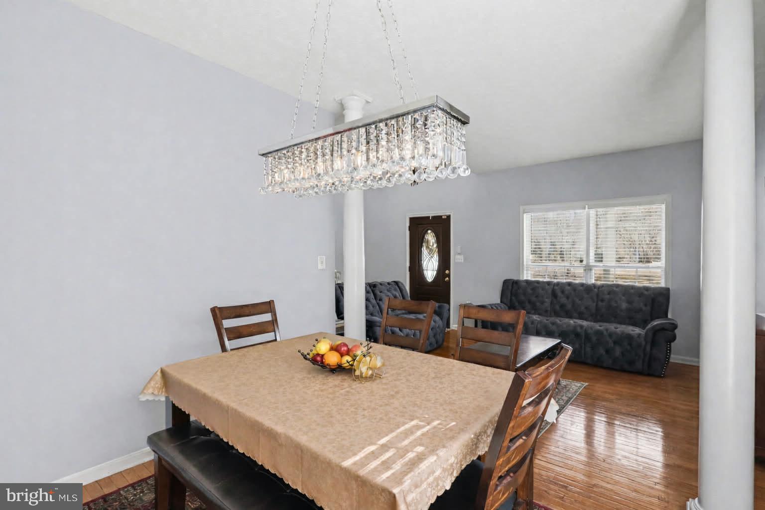 209 Estate Drive Ruther Glen, VA 22546 - Photo 11 of 67 a living room with furniture and a chandelier