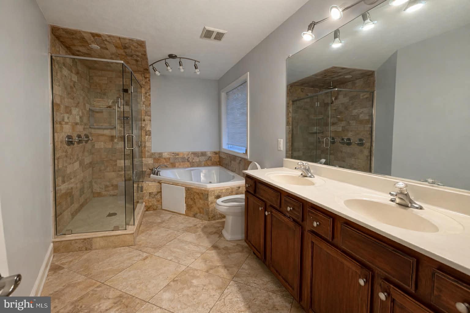 209 Estate Drive Ruther Glen, VA 22546 - Photo 19 of 67 a spacious bathroom with a shower sink mirror and toilet