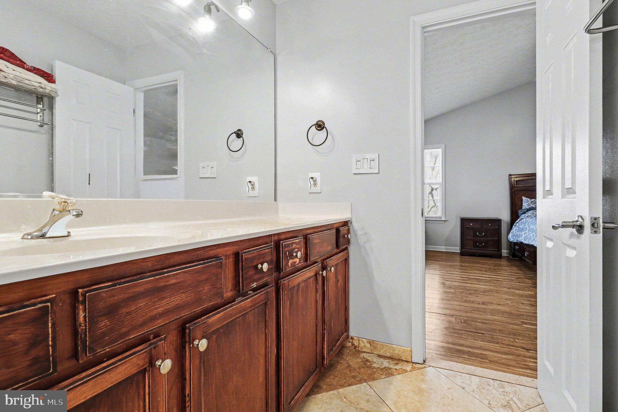 209 Estate Drive Ruther Glen, VA 22546 - Photo 22 of 67 a bathroom with a sink a mirror and a shower
