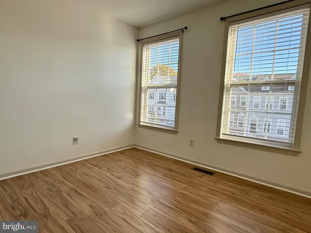 a view of a room with wooden floor and stairs