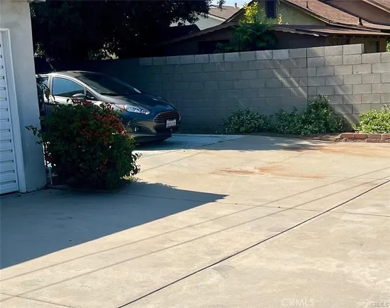 a view of a house with a large window and wooden fence