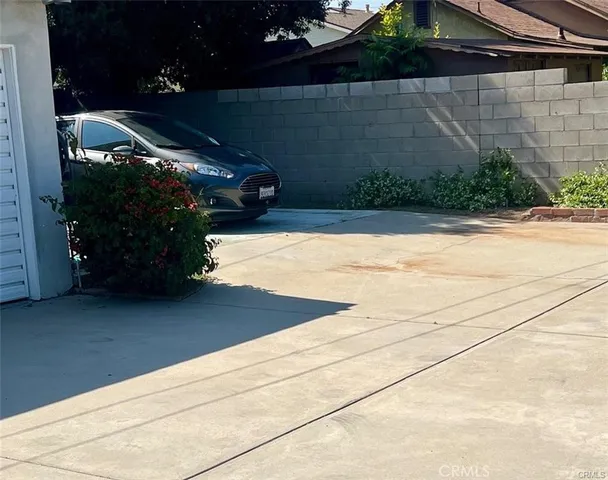 a view of a house with a large window and wooden fence