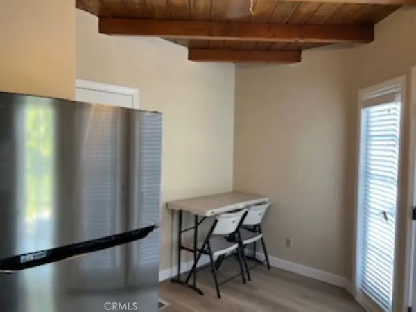a view of a room with furniture and a window
