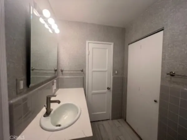 a bathroom with a sink and mirror