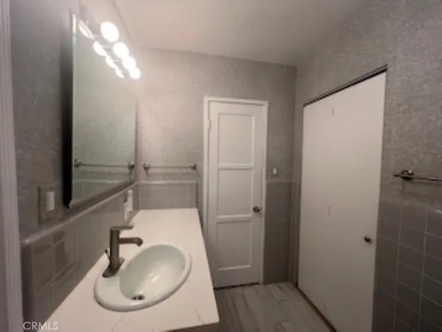 a bathroom with a sink and mirror