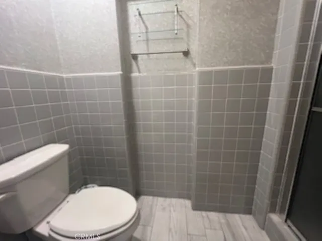 a white toilet sitting next to a bathroom sink