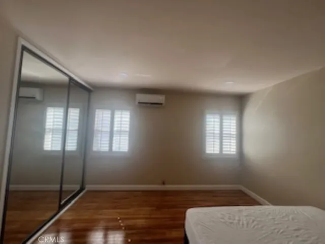 an empty room with windows and closet
