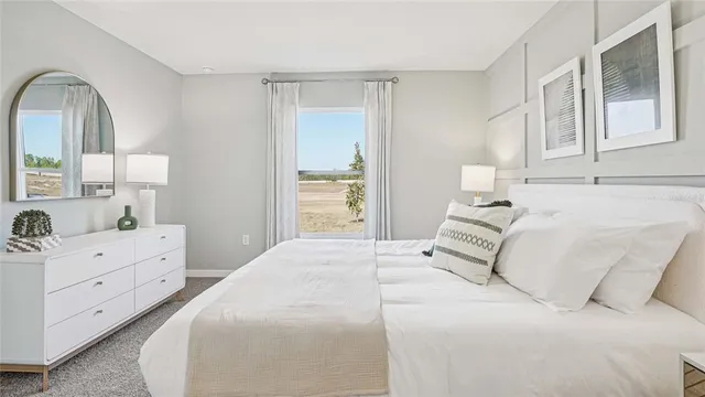 a large white bed in a white room