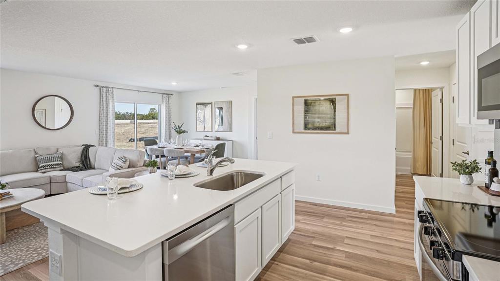 15880 Southeast 101st Ct Road Summerfield, FL 34491 - Photo 5 of 32 a kitchen with a sink and a refrigerator