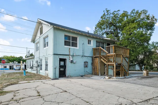 a view of a house with a yard and tree s