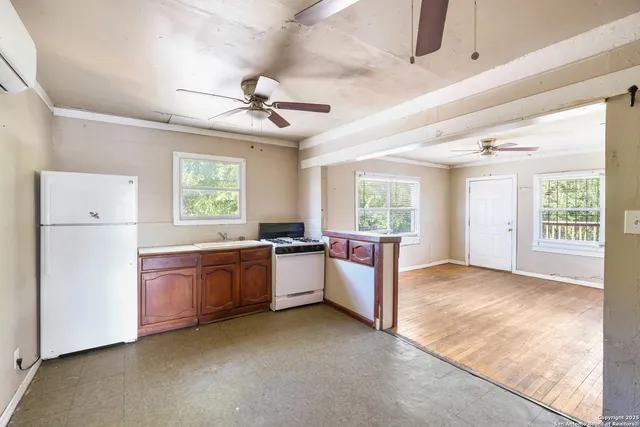 a large bedroom with a large bed and chandelier