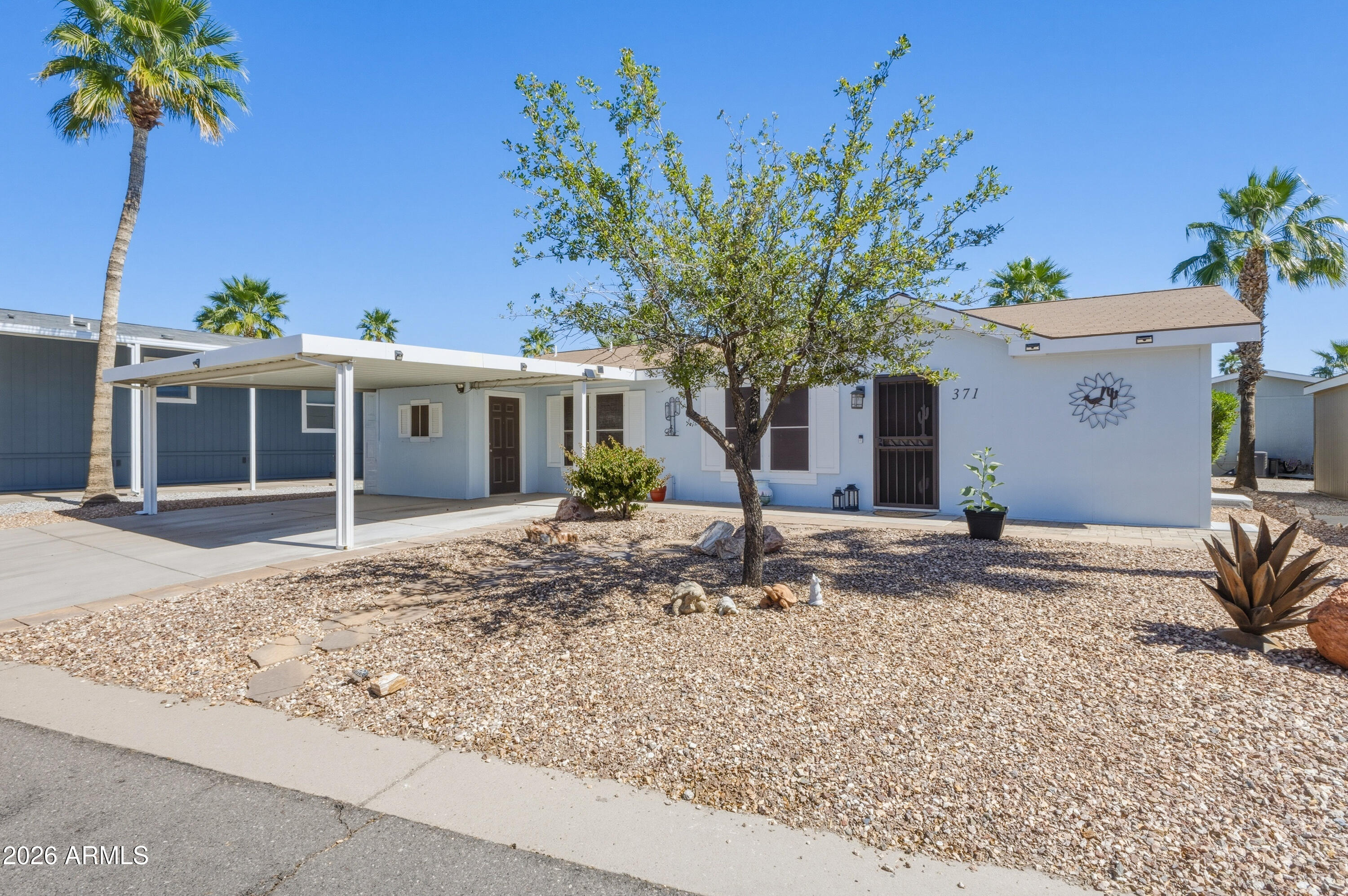 2000 South Apache Road, Unit 371 Buckeye, AZ 85326 - Photo 1 of 38 a front view of a house with garden