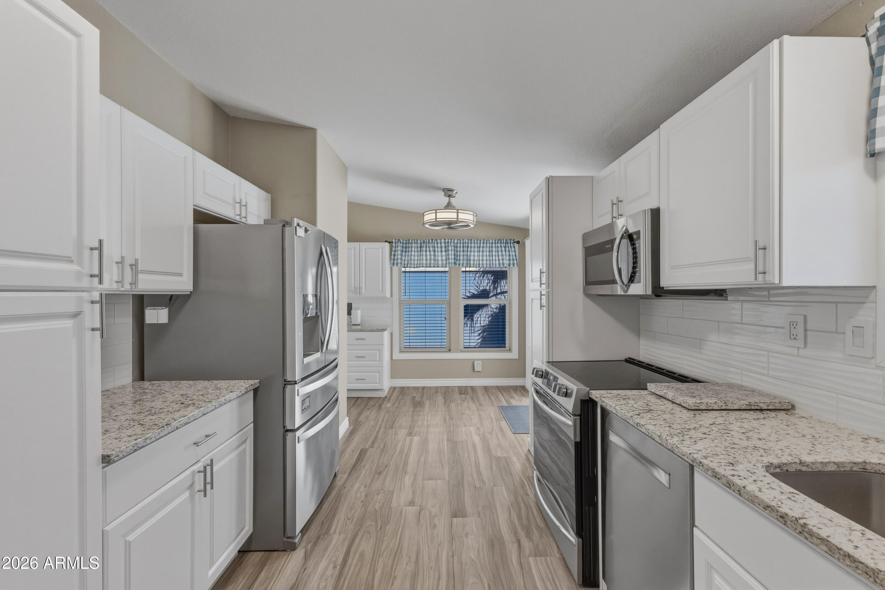 2000 South Apache Road, Unit 371 Buckeye, AZ 85326 - Photo 13 of 38 a kitchen with stainless steel appliances granite countertop a refrigerator and a sink
