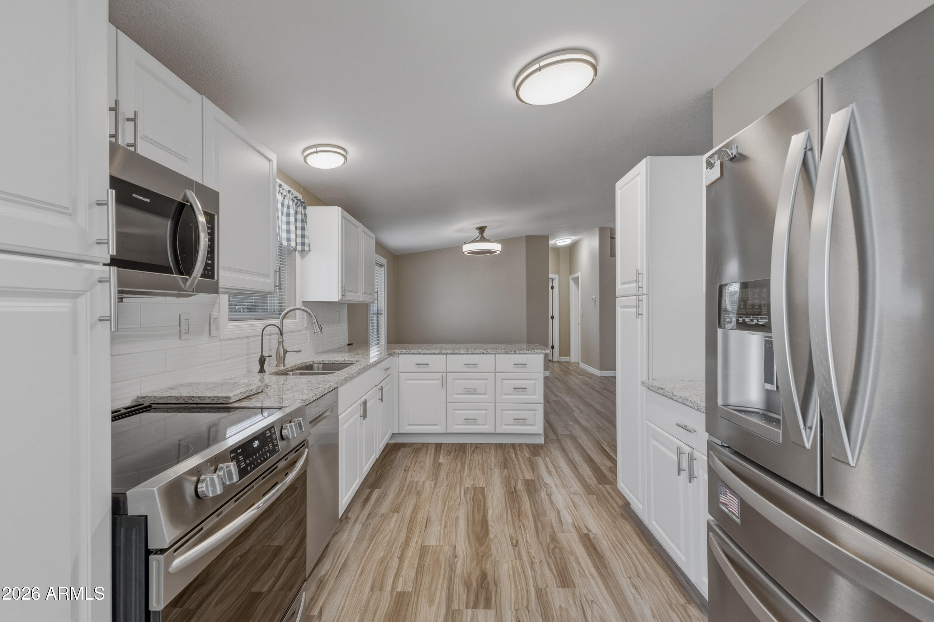 2000 South Apache Road, Unit 371 Buckeye, AZ 85326 - Photo 16 of 38 a kitchen with stainless steel appliances a sink stove and refrigerator