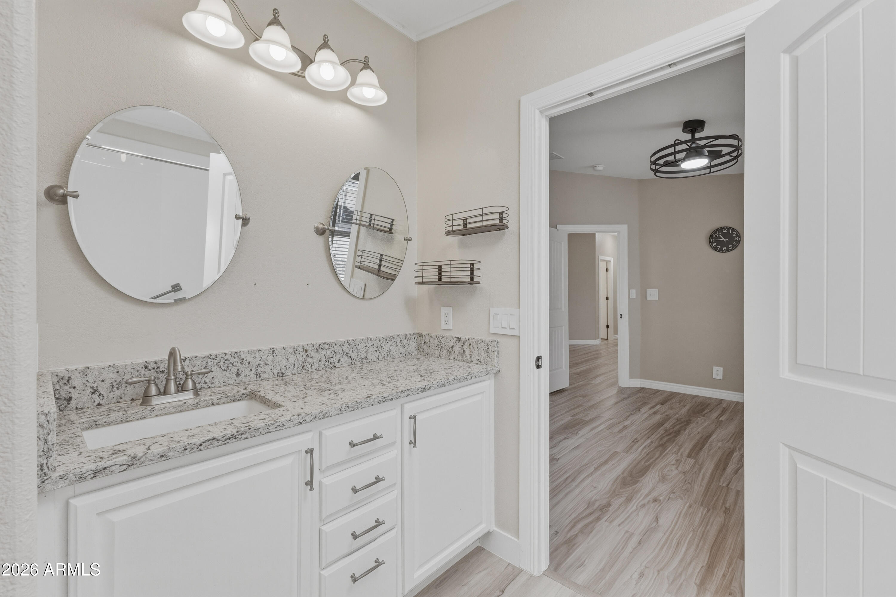2000 South Apache Road, Unit 371 Buckeye, AZ 85326 - Photo 23 of 38 a bathroom with a granite countertop sink mirror and vanity