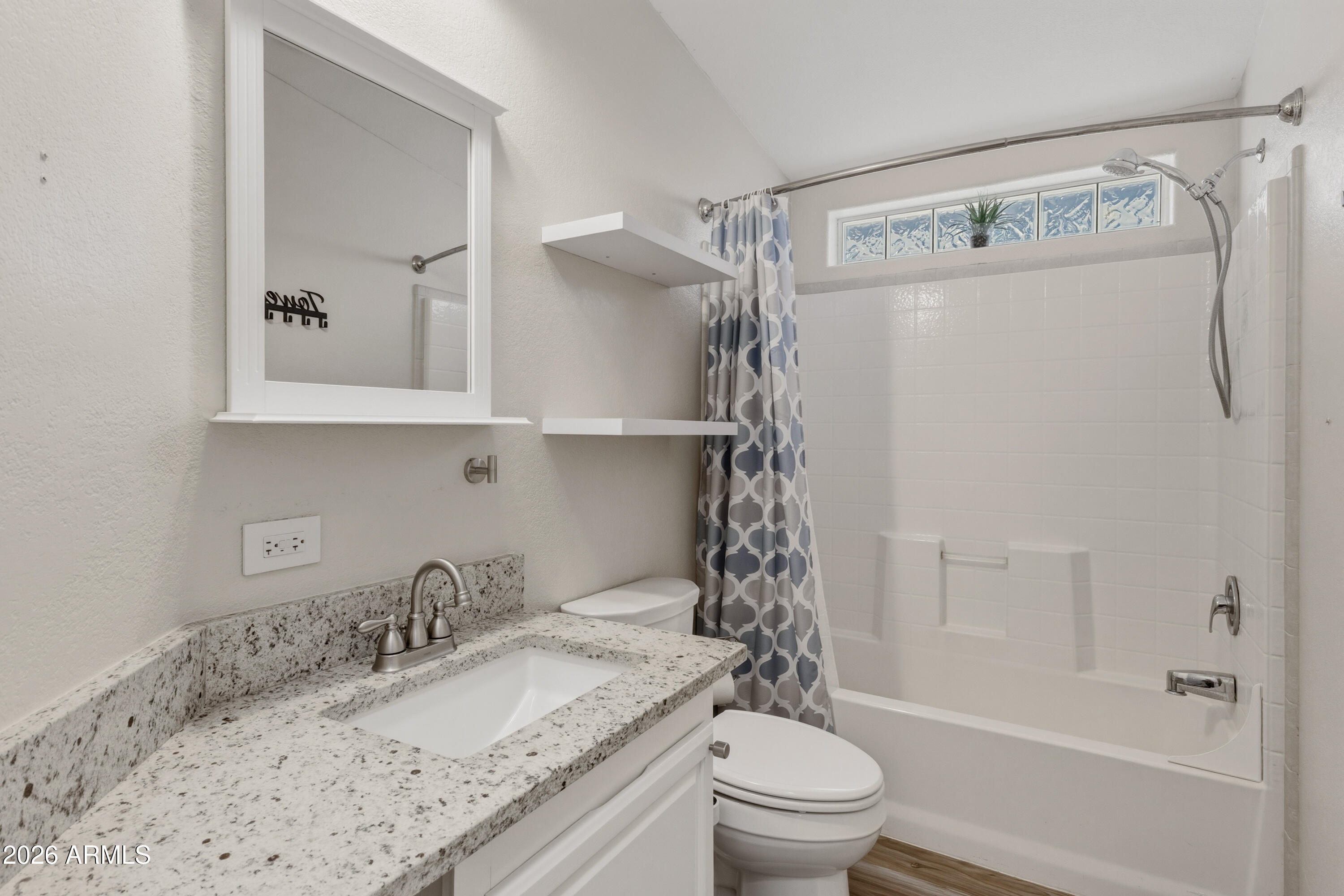 2000 South Apache Road, Unit 371 Buckeye, AZ 85326 - Photo 26 of 38 a bathroom with a granite countertop sink toilet and shower