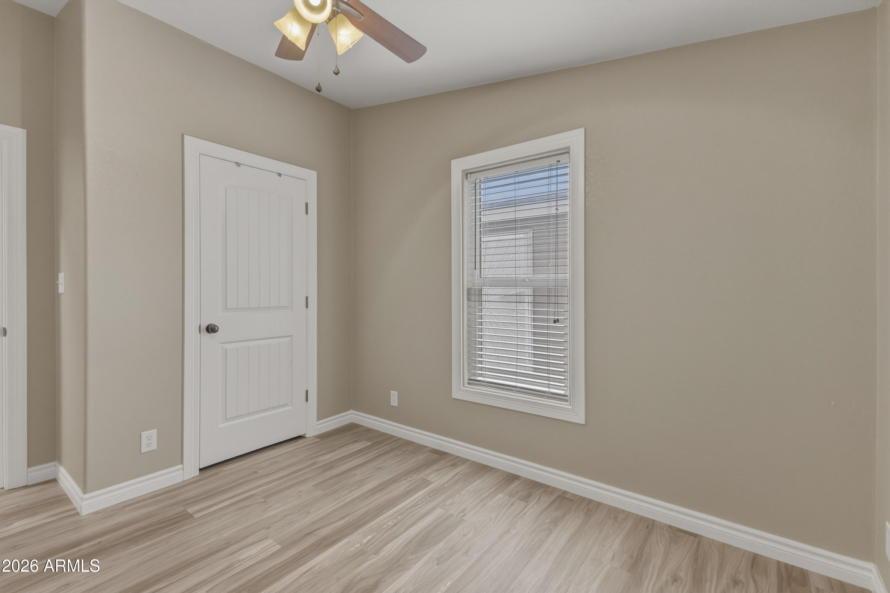 2000 South Apache Road, Unit 371 Buckeye, AZ 85326 - Photo 28 of 38 a view of an empty room with wooden floor and a window