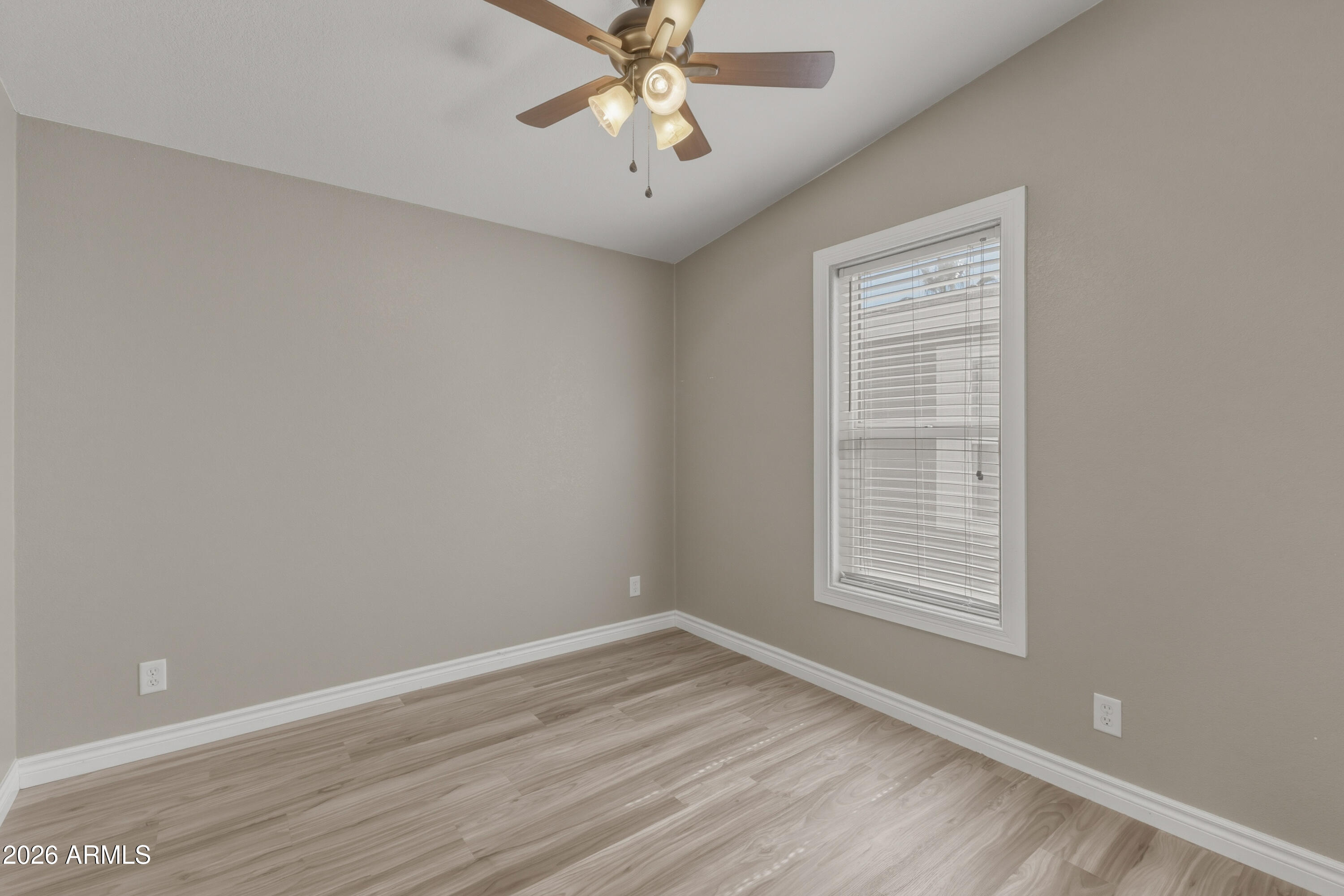 2000 South Apache Road, Unit 371 Buckeye, AZ 85326 - Photo 29 of 38 an empty room with a window and a fan