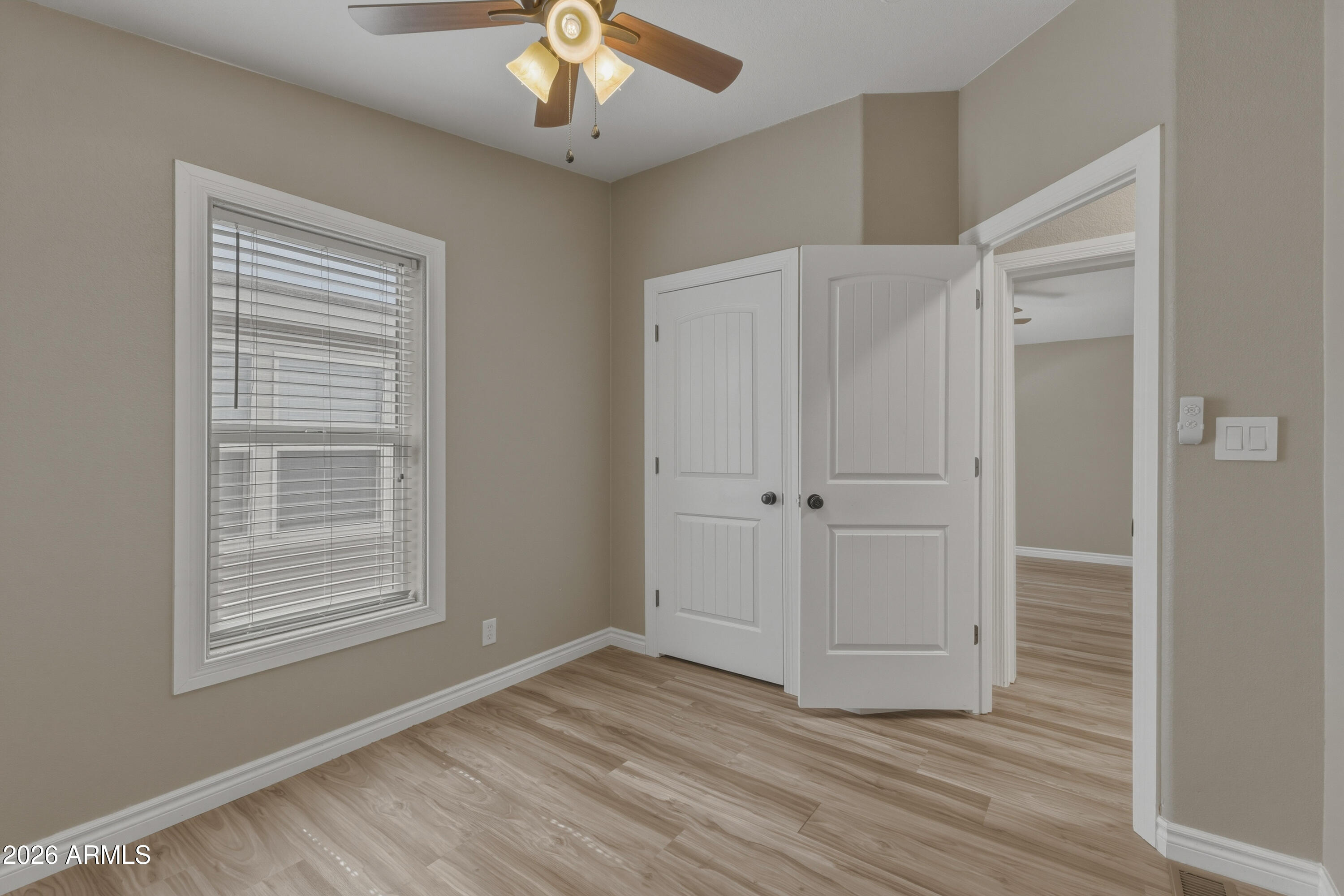 2000 South Apache Road, Unit 371 Buckeye, AZ 85326 - Photo 30 of 38 a view of an empty room with wooden floor and a window