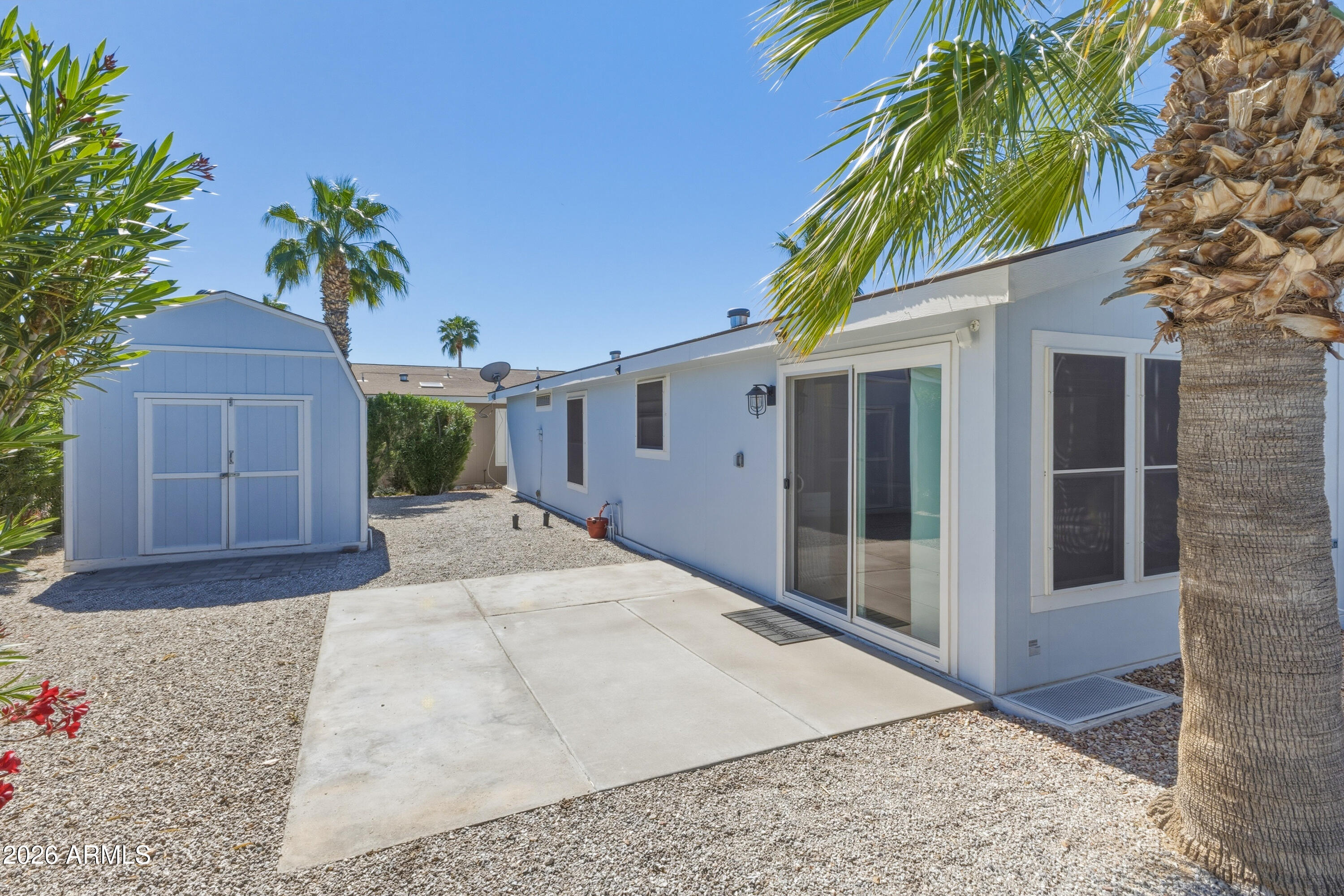 2000 South Apache Road, Unit 371 Buckeye, AZ 85326 - Photo 34 of 38 a white house with a yard and plants