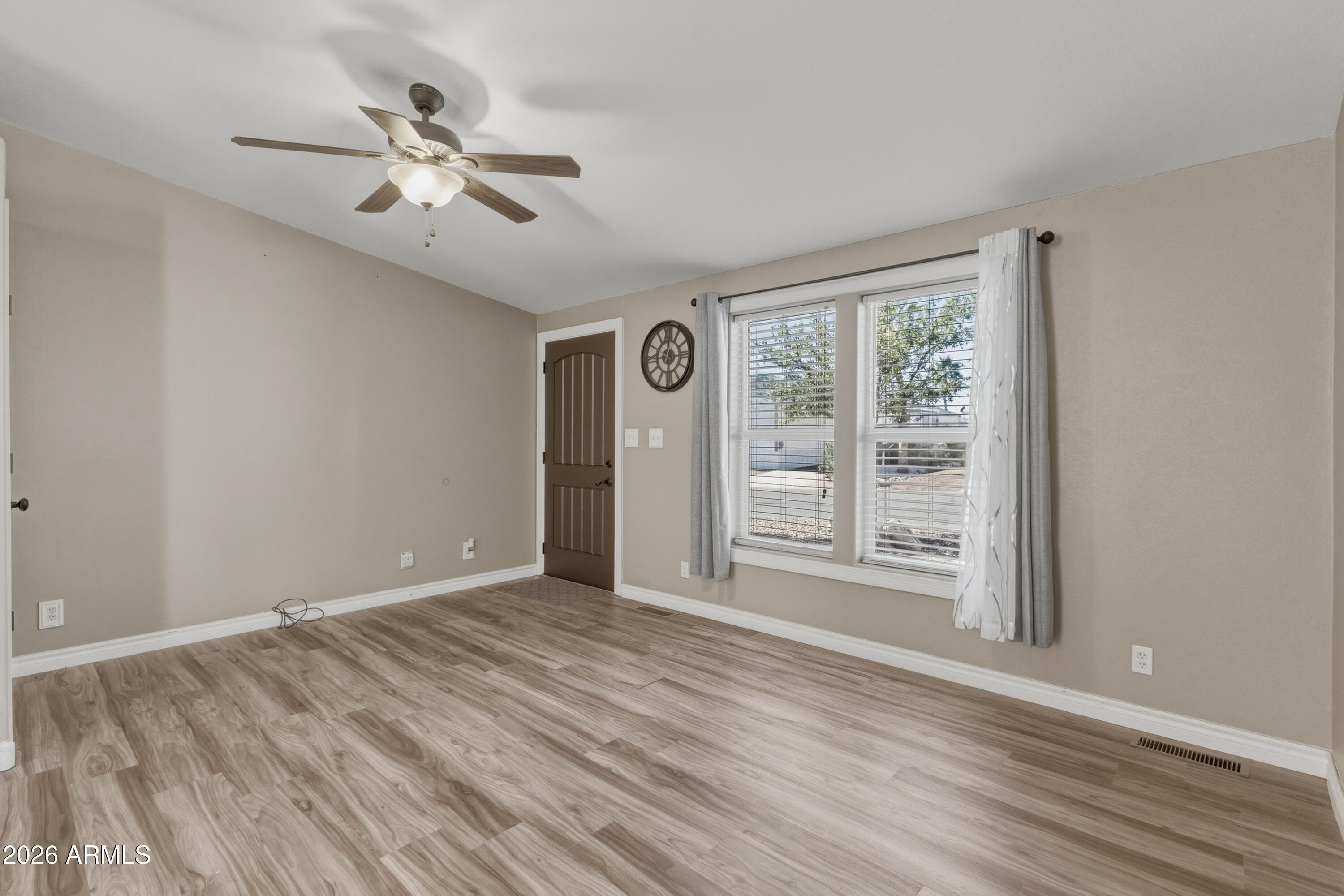 2000 South Apache Road, Unit 371 Buckeye, AZ 85326 - Photo 5 of 38 a view of an empty room with a window and wooden floor