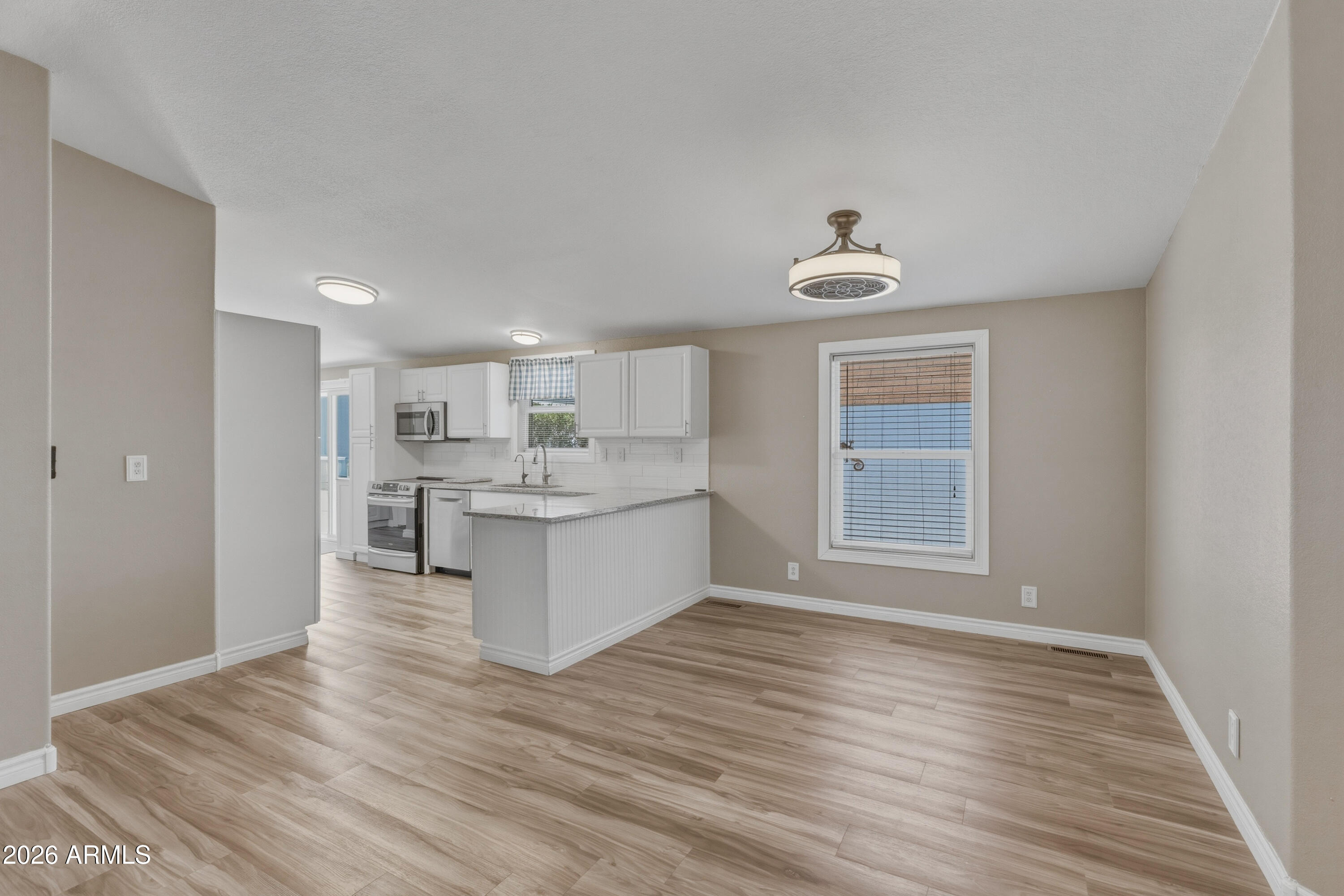 2000 South Apache Road, Unit 371 Buckeye, AZ 85326 - Photo 6 of 38 a view of kitchen and front door with wooden floor