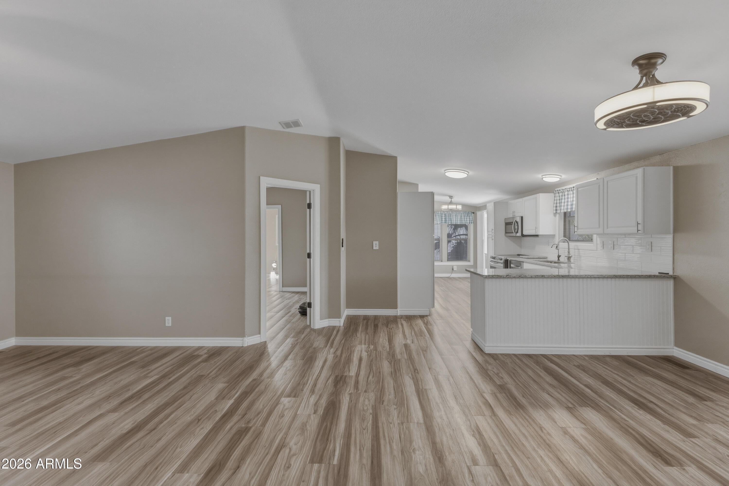 2000 South Apache Road, Unit 371 Buckeye, AZ 85326 - Photo 7 of 38 a view of a kitchen with wooden floor and a sink