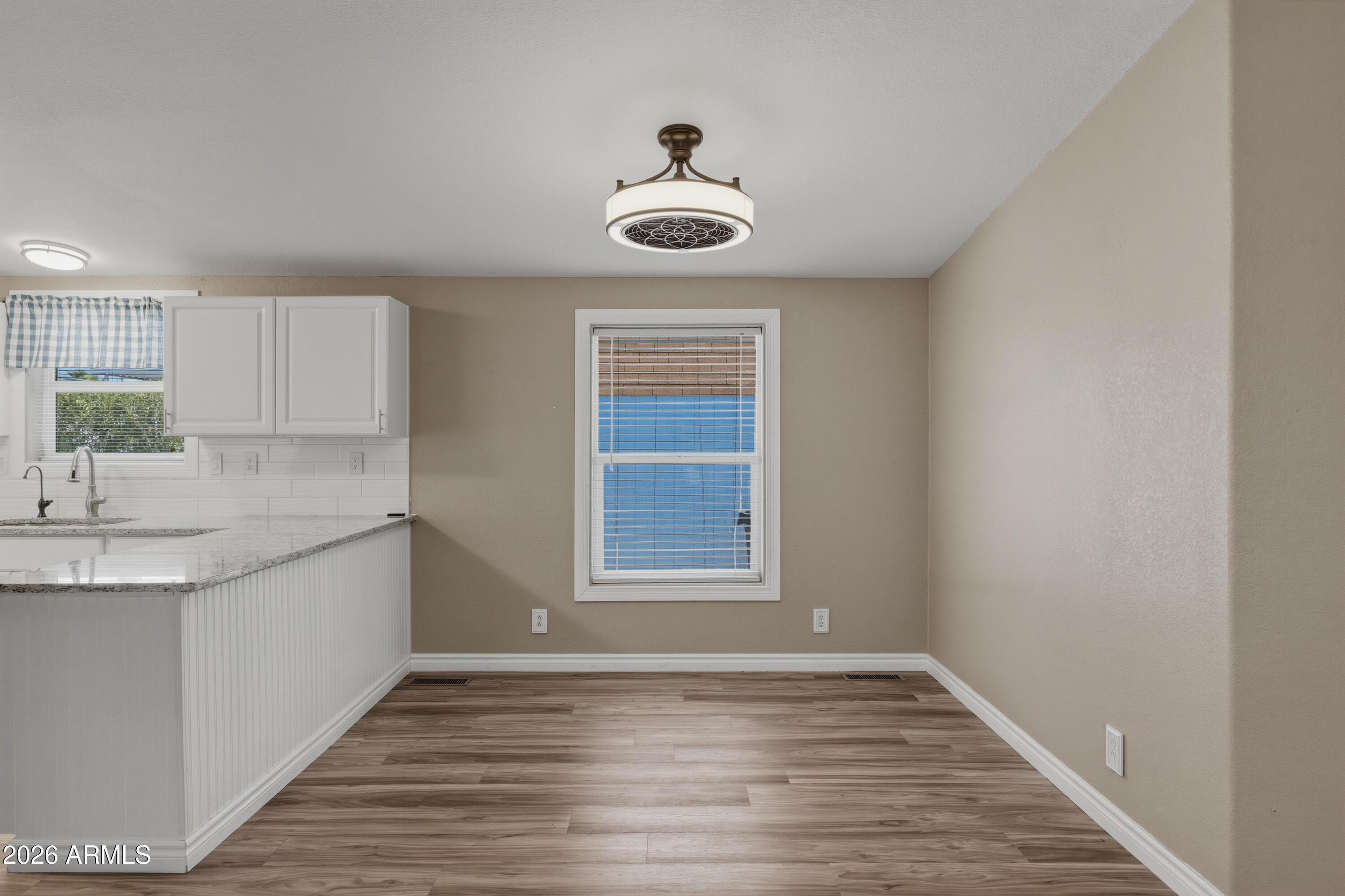 2000 South Apache Road, Unit 371 Buckeye, AZ 85326 - Photo 9 of 38 a view of an empty room with wooden floor and a window