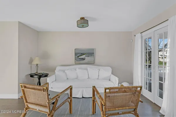 a living room with furniture a flat screen tv and a table