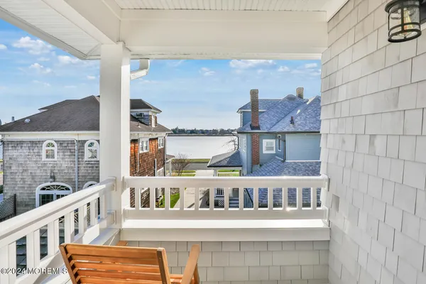 a view of a balcony with furniture and a window