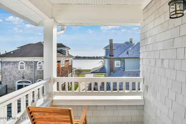 a view of a balcony with furniture and a window