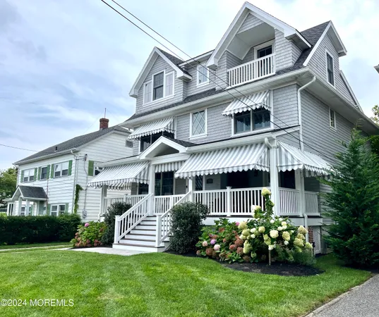 a front view of a house with a garden and plants