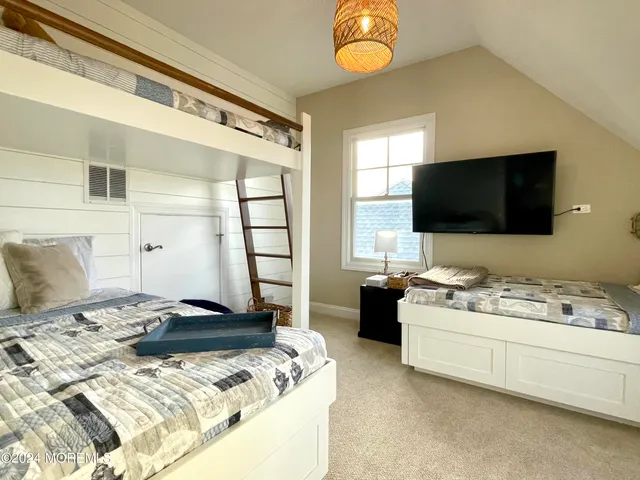 a bedroom with a bed and flat screen tv