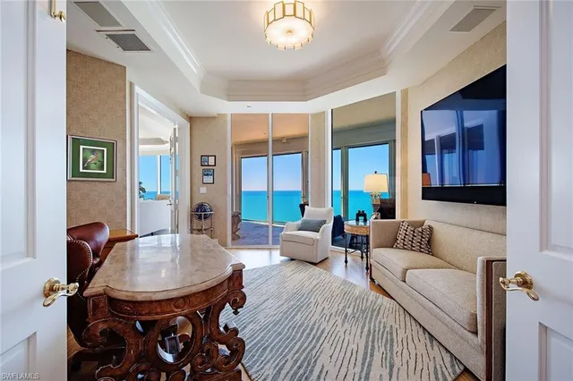 a living room with furniture and a chandelier