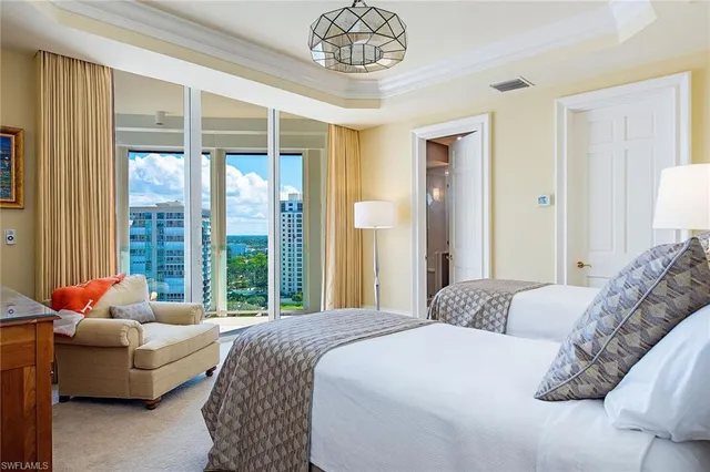 a bedroom with bed couch and window