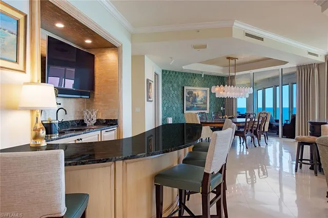 a kitchen with granite countertop a table chairs stove and cabinets
