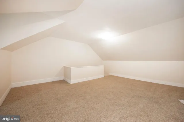 an empty room with a windows and closet