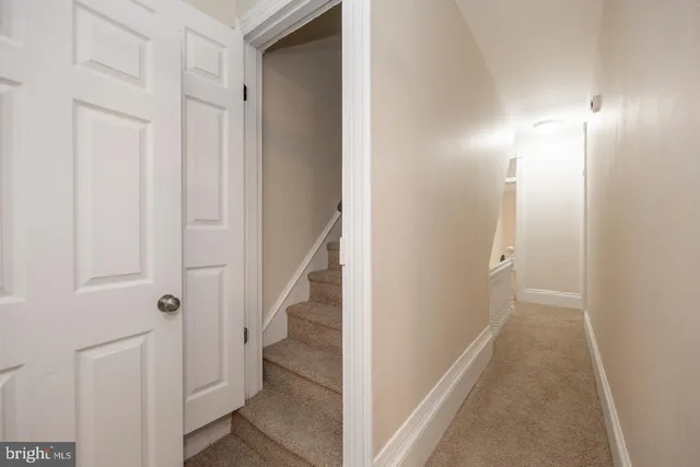 a view of a hallway with wooden floor and entryway