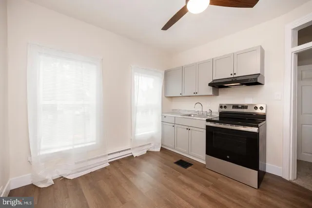 a kitchen with granite countertop a stove and a sink