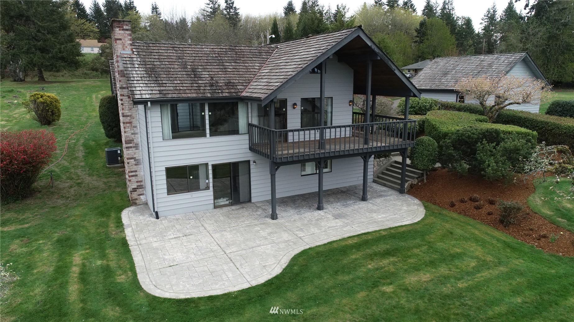 2530 Mountain View Road East Port Orchard, WA 98366 - Photo 1 of 34 a view of a house with a yard potted plants and a bench