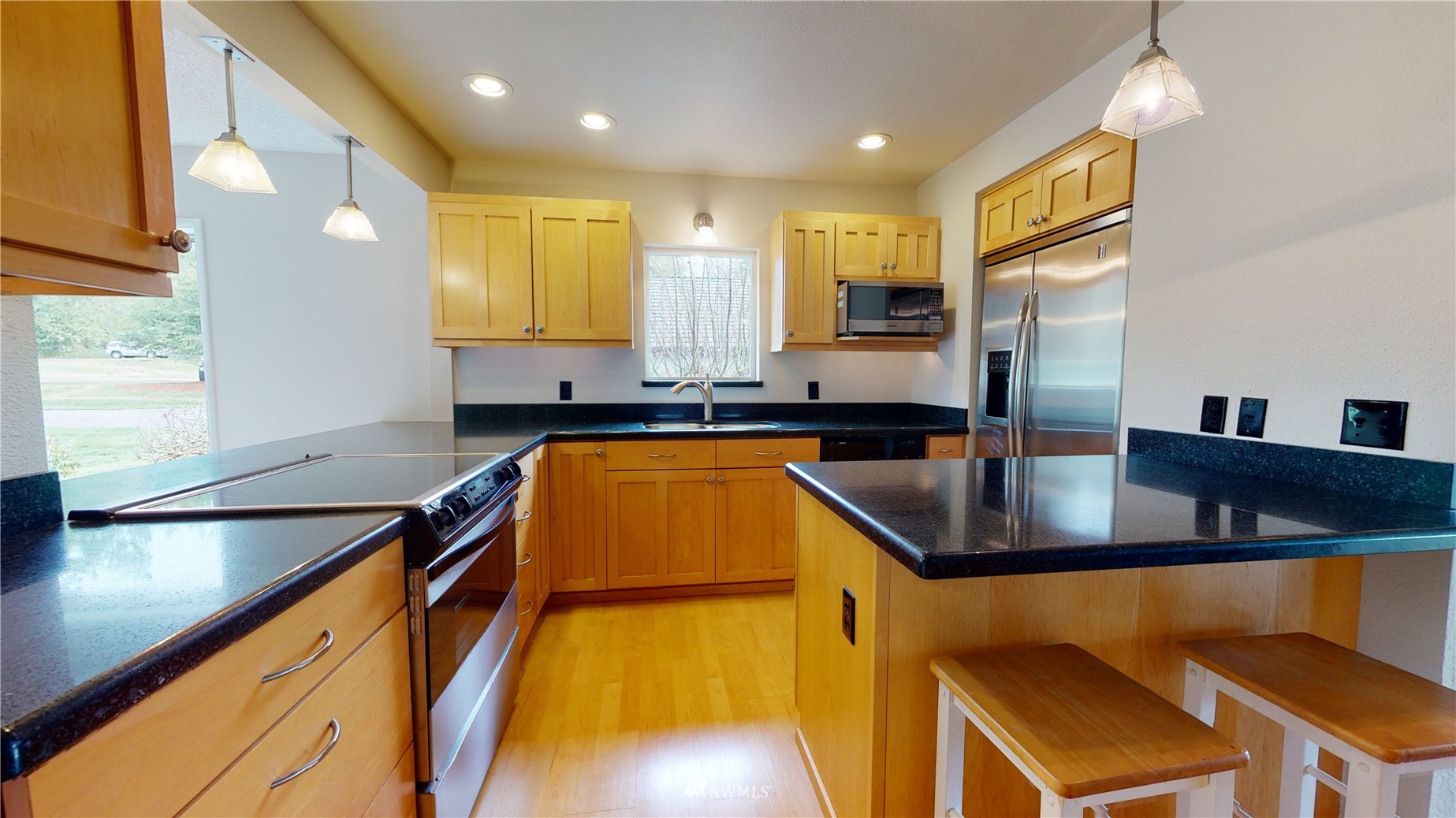 2530 Mountain View Road East Port Orchard, WA 98366 - Photo 18 of 34 a kitchen filled with stainless steel appliances granite countertop a sink a stove and a refrigerator